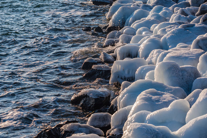 Frozen rocks in sea during winter