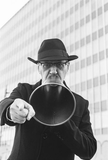 Portrait of man wearing hat and a megaphone 