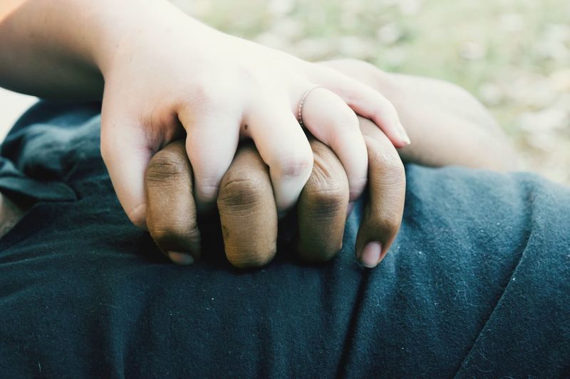 Cropped image of couple holding hands