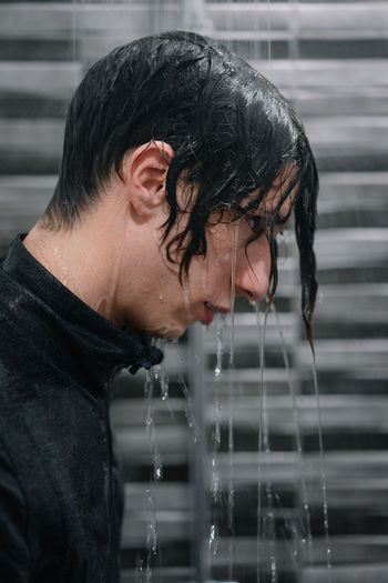 Side view of man taking shower