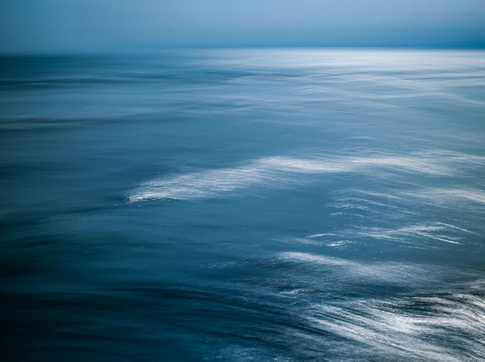 Aerial view of seascape against sky at dusk