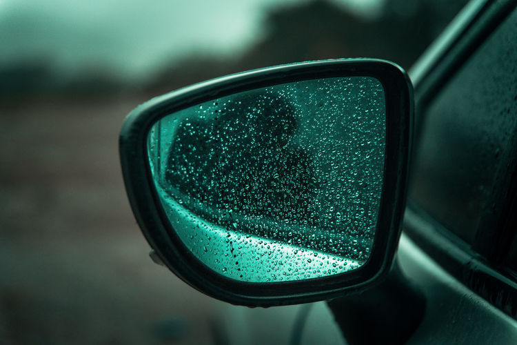 Reflection on side-view mirror of car