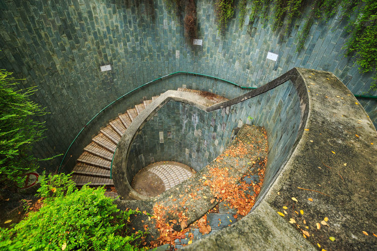 High angle view of empty steps by wall