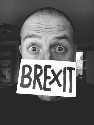 Close-up of person with sign on his face