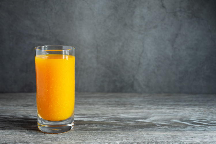 Close-up of orange juice on table