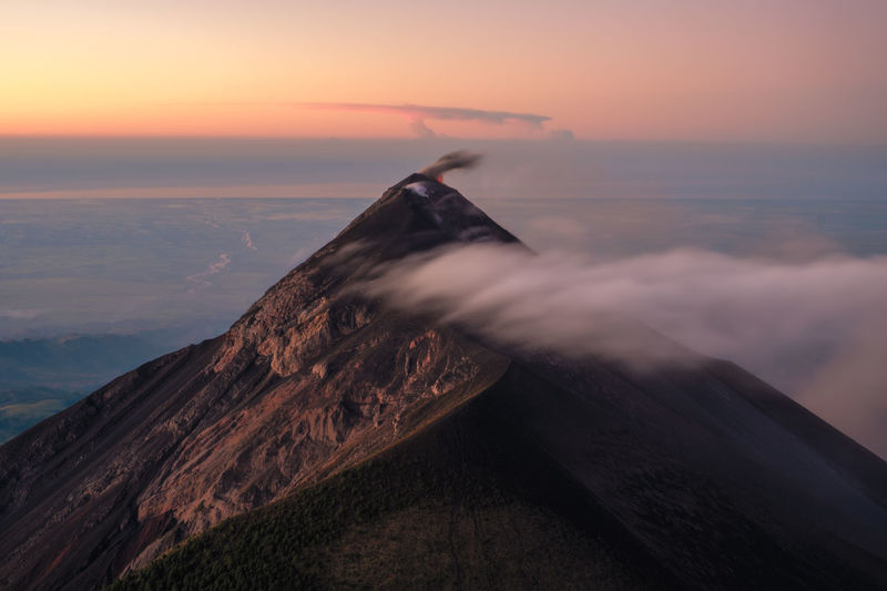 Unforgettable sunset over the volcano fuego in guatemala, took after a cold night on the acatenango