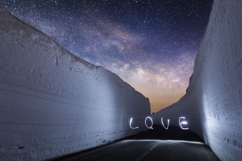 Light painting of the word "love" on road at night