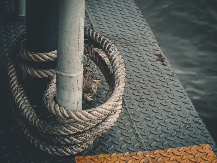 Close-up of rope tied to pole