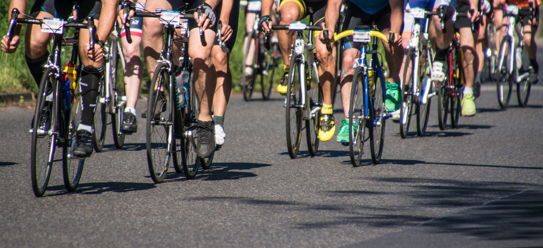 Low section of people riding bicycles on street