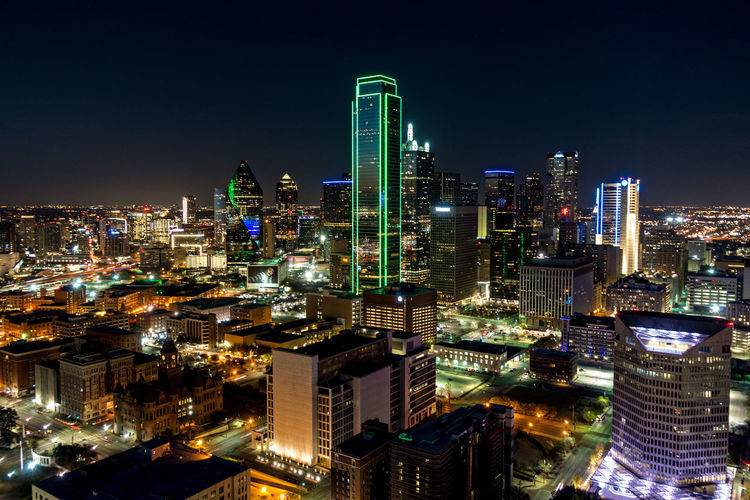 Aerial view of city lit up at night