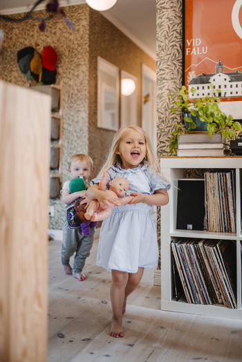 Happy girl running with doll