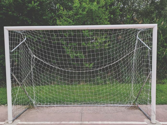 View of soccer field seen through metal fence