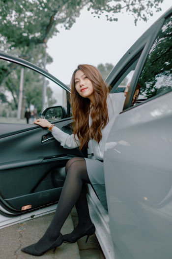 Beautiful woman sitting in car