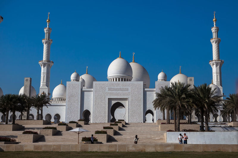 Low angle view of sheikh zayed mosque against clear blue sky