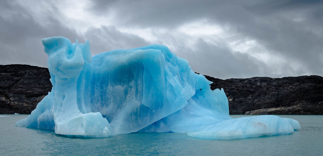 Scenic view of ice floating on sea against sky