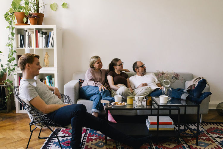 Family spending leisure time together watching movie in living room at home