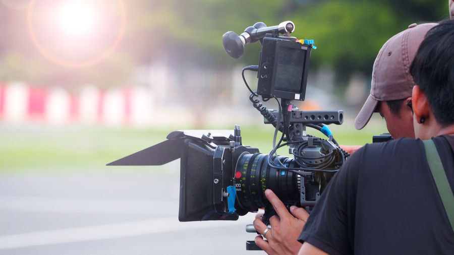 Reflection of man photographing on camera