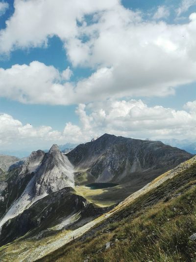 Scenic view of mountains against cloudy sky