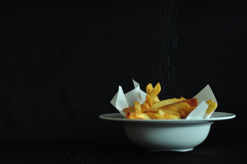 Close-up of food on table against black background