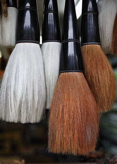 Close-up of paintbrushes in container