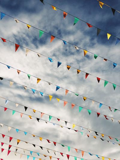 Low angle view of buntings hanging against sky