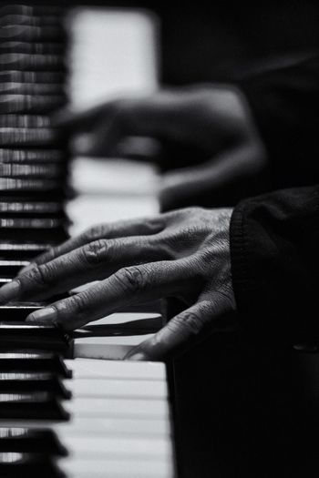 Cropped image of woman hands playing piano