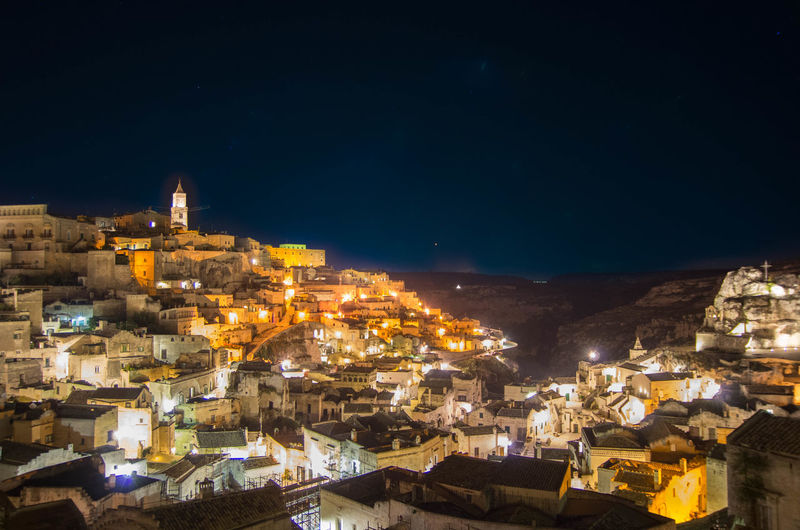 High angle view of illuminated town against sky at night