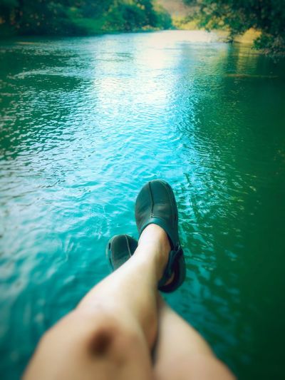 Low section of woman relaxing in lake