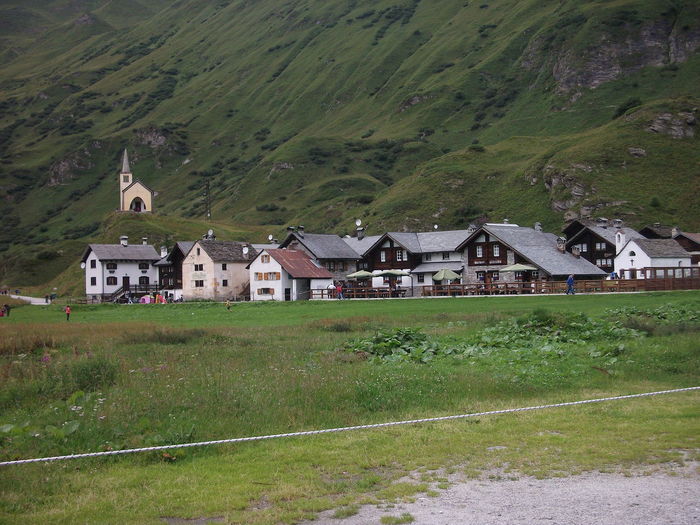 Houses on field by mountain