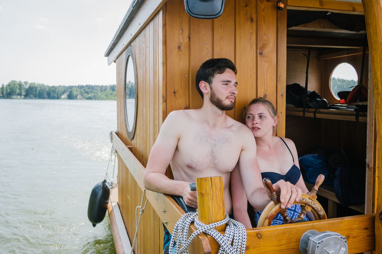 Couple sitting in boat over river