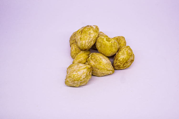 Close-up of fresh green pepper against white background