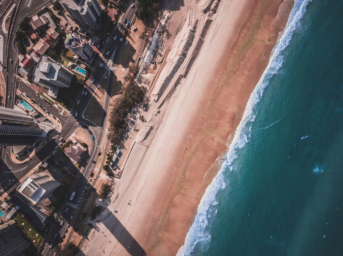 High angle view of buildings by sea against sky
