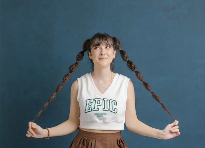 Young woman playing with plaits