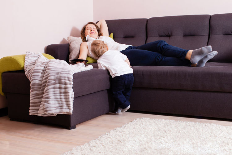 People relaxing on sofa at home