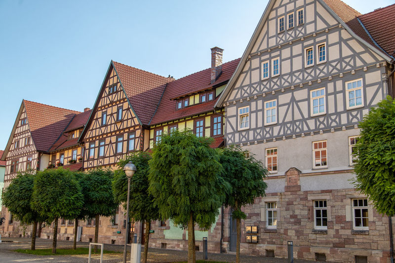 Facades of historic half-timbered houses and trees in wasungen, thuringia
