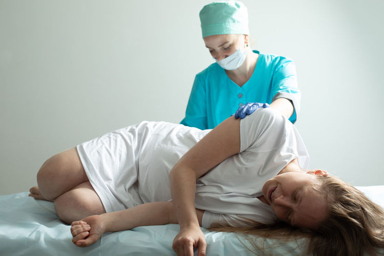 High angle view of doctor examining patient at home