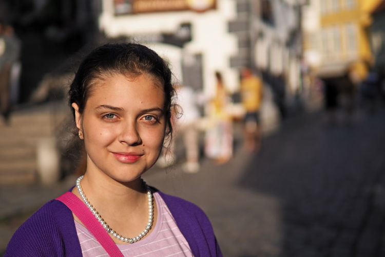 Portrait of a smiling young girl in city