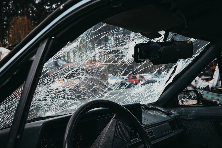 Close-up of broken windshield in car