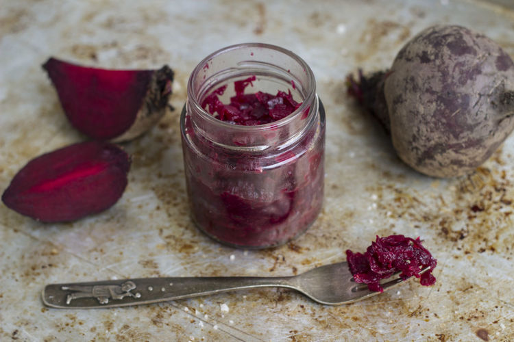 High angle view of beetroot chutney in jar in table