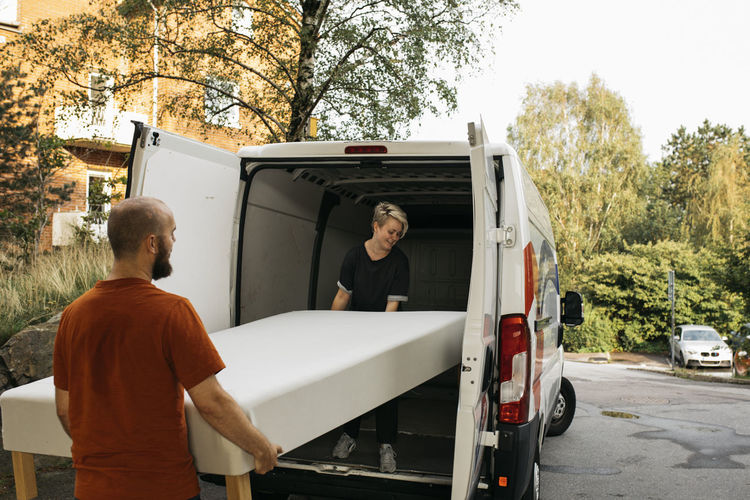 Couple putting bed into van