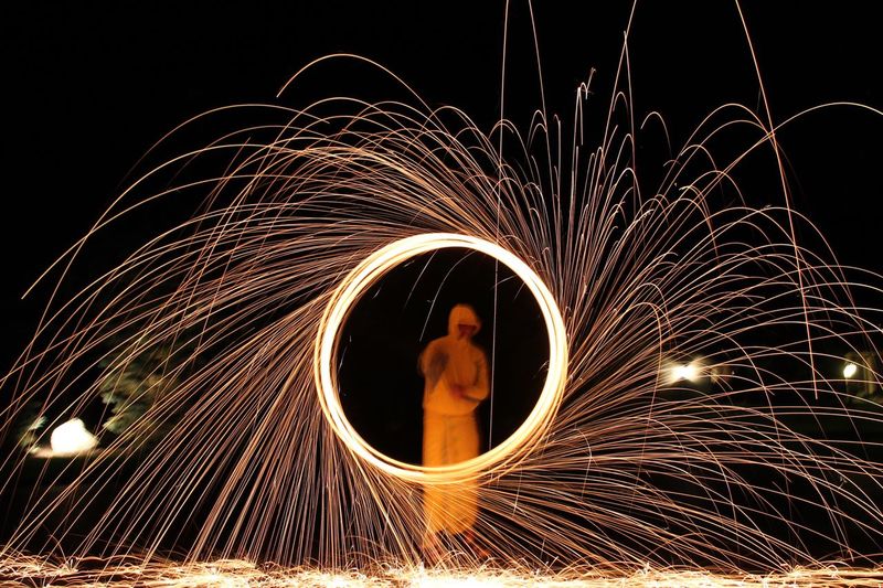 Person performing with wire wool at night