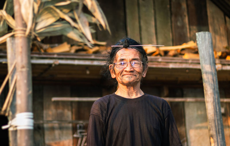 Portrait of smiling senior man standing outdoors