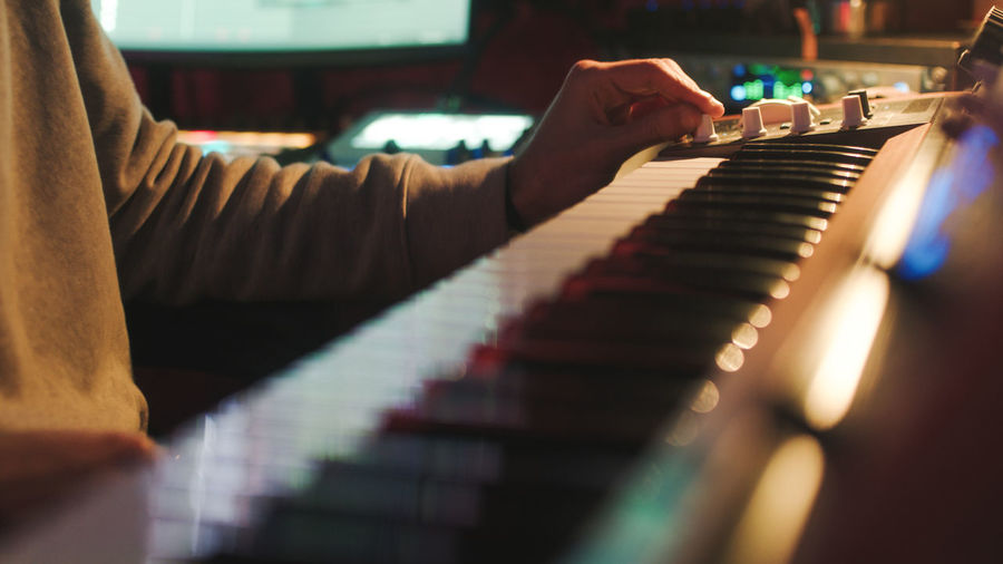Hand on piano during recording studio session