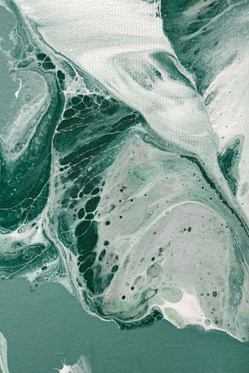 Acrylic fluid art. turquoise waves and frothy bubbles flow. digital decor. abstract stone background