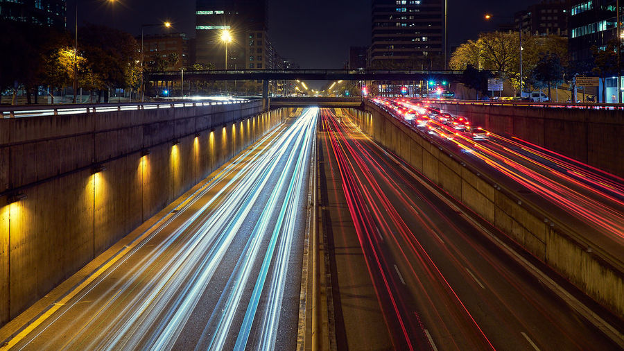 High angle view of light trails on road at night