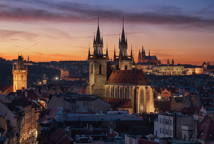 View of buildings in city at sunset