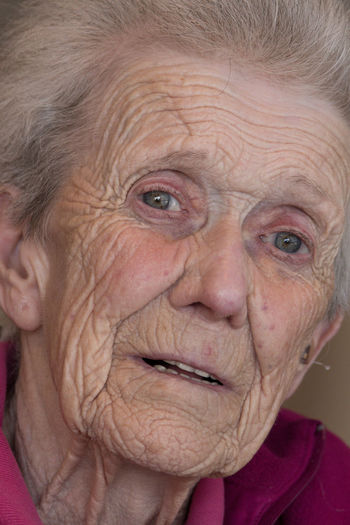 Close-up portrait of wrinkled senior woman