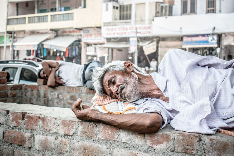 Homeless men sleeping on brick walls
