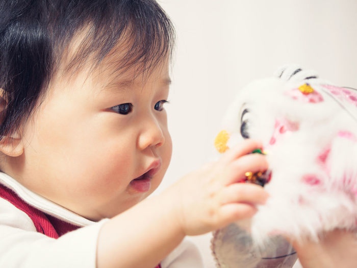 Close-up of cute girl playing with toy at home