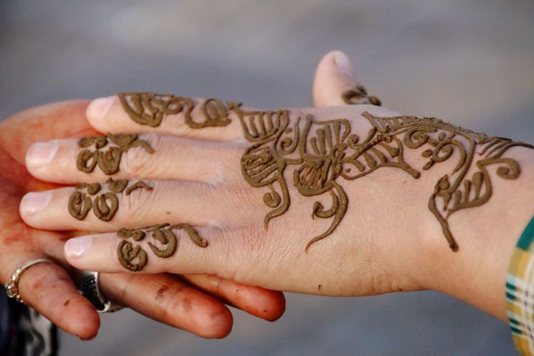 Close-up of woman hand with henna tattoo 